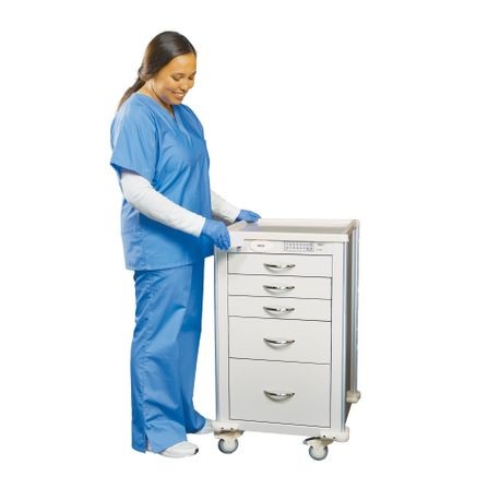 A healthcare professional in blue scrubs is pushing a white aluminum mini cart with multiple drawers.