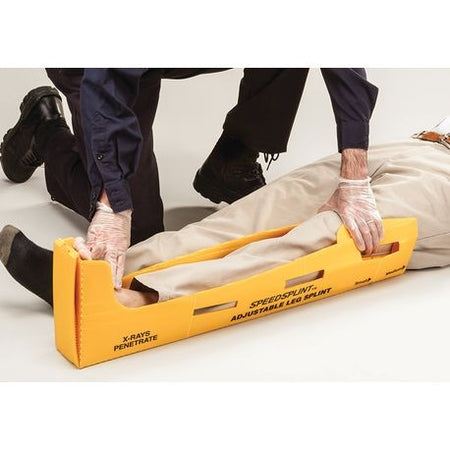 A medical professional is handling a yellow disposable splint with black straps, which is designed for patient immobilization.