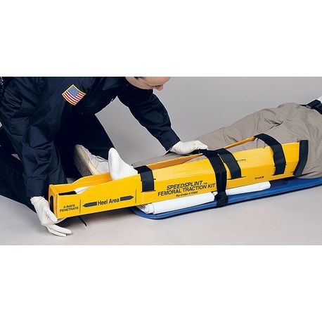 A medical professional is handling a yellow disposable splint with black straps, which is designed for patient immobilization.