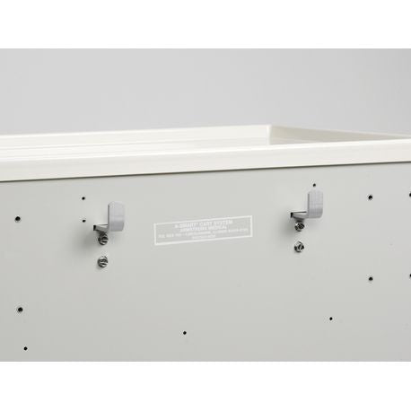 A set of silver utility hooks mounted on the side of a white medical cart.