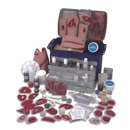 A casualty simulation kit with various medical training props including pretend blood, injuries, and medical equipment displayed around an open case.