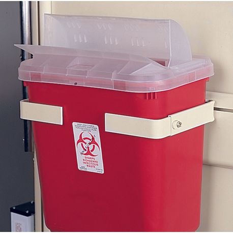 A red hazardous waste container with a clear lid and a biohazard sign on it, secured on a bracket mounted to a wall.