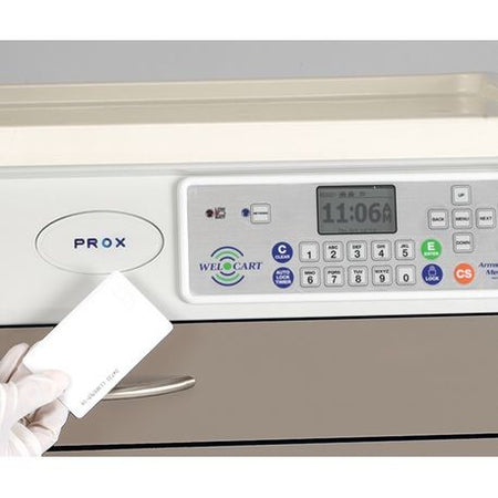 A hand holding a white card with aProx logo, in front of a digital control panel of a device.